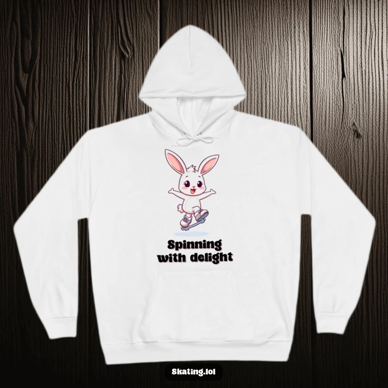 Funny hoodie featuring a delighted bunny character energetically bouncing and attempting a graceful spin on ice skates, radiating happiness.